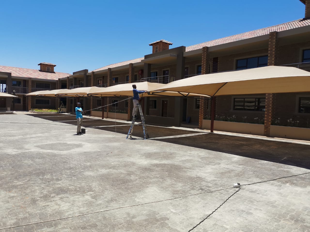 Long row of beige shadeports at a residential complex