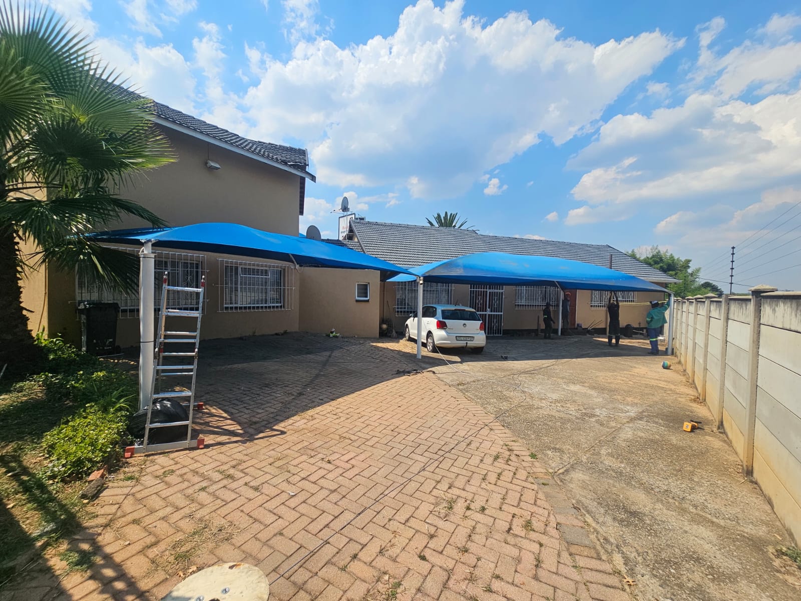 Two bright blue residential shadeports