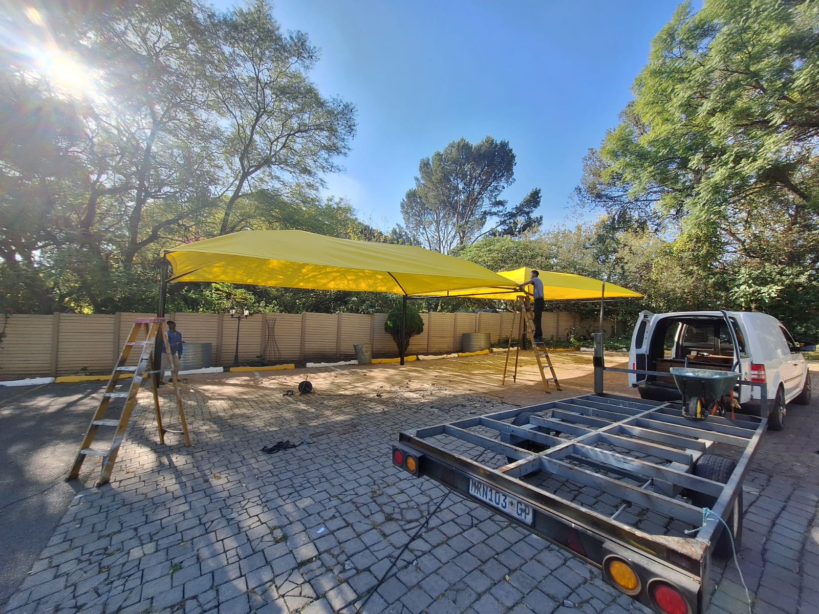 Yellow multi-bay shadeport under tall trees